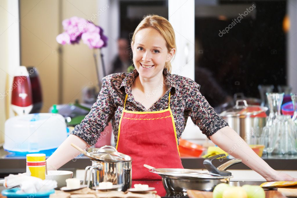 Smiling woman cooking in her kitchen