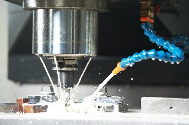 Milling the metal blank with coolant clipart