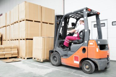 Worker driver at warehouse forklift loader works clipart