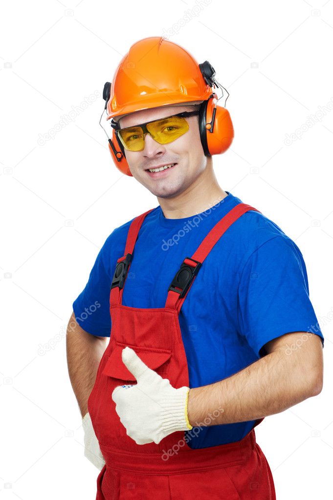 Builder in hardhat, earmuffs, goggles and gas mask