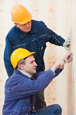 Electricians at cable wiring work clipart