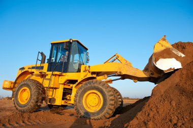 Wheel loader excavator at work clipart