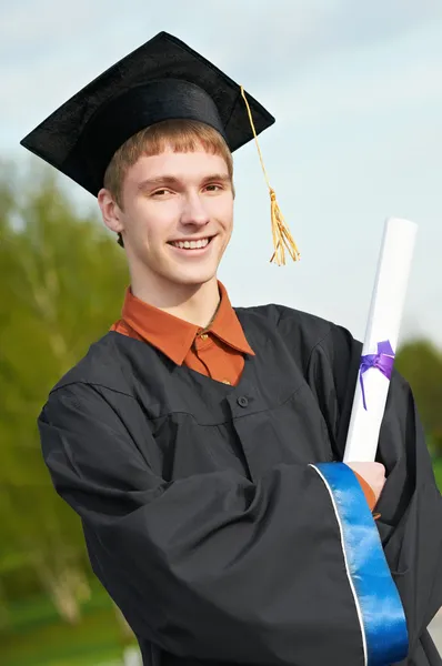 Graduate student in gown with diploma — Stock Photo, Image