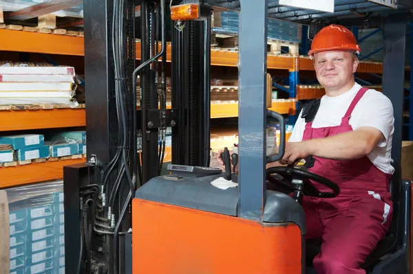 Warehouse forklift worker at work — Stock Photo, Image