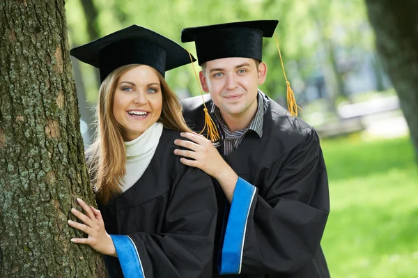 Graduate students on grass — Stock Photo, Image