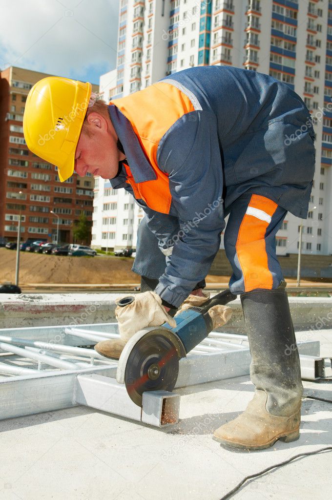 Builder working with cutting grinder