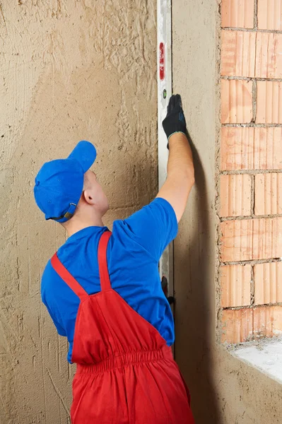 Construction worker plasterer with level — Stock Photo, Image
