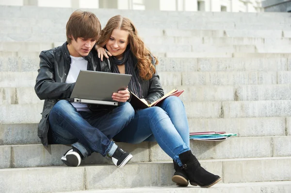 Two smiling young students outdoors — Stok fotoğraf