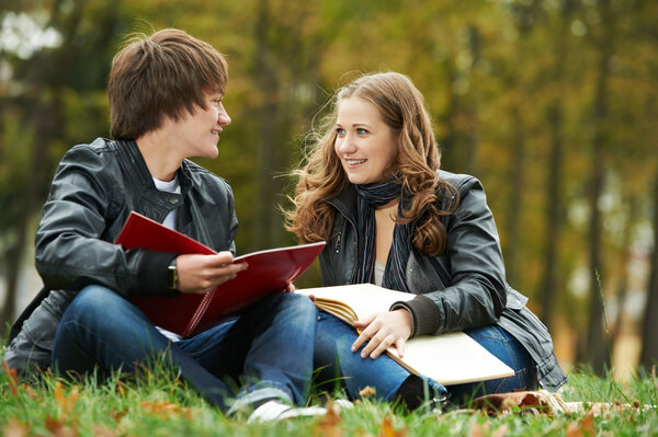 Two smiling young students outdoors