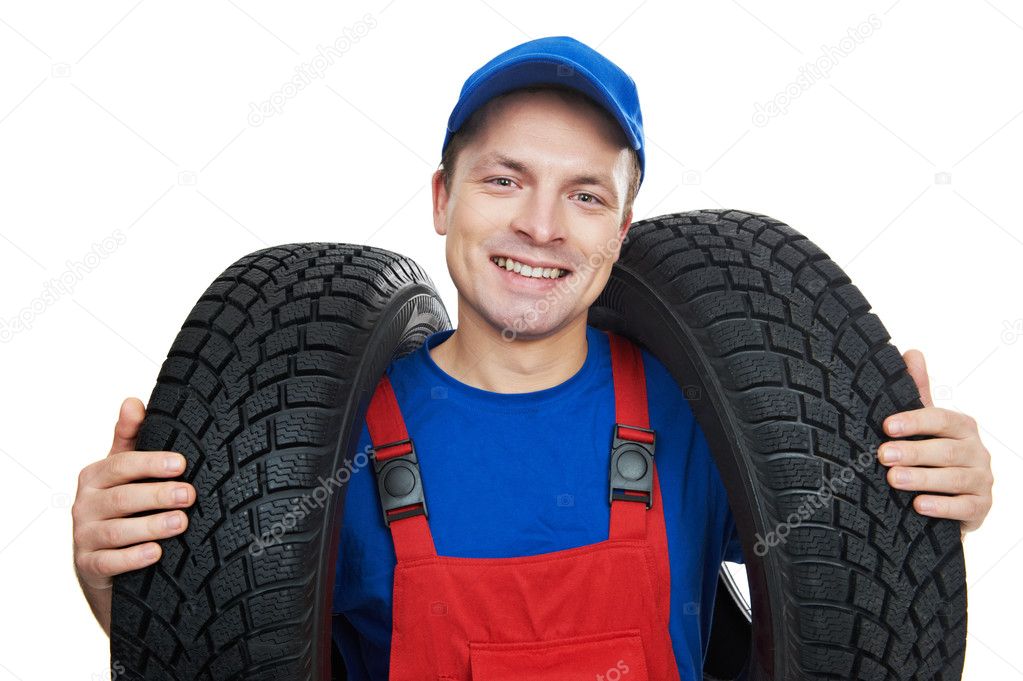 Automobile mechanic with car tire