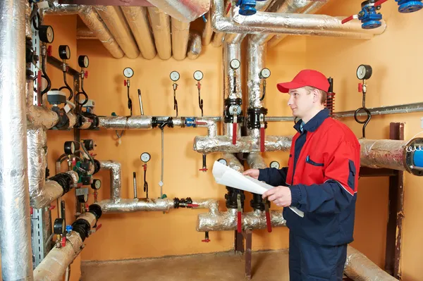 Heating engineer repairman in boiler room Royalty Free Stock Images