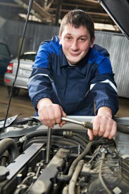 Happy automotive mechanic at work with wrench clipart