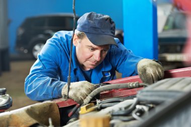 Car mechanic diagnosing auto engine problem clipart