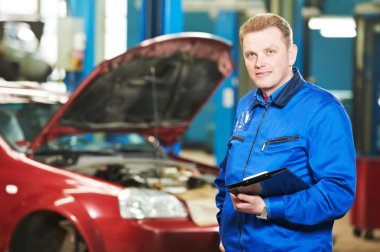 Happy mechanic technician at service station clipart