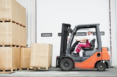 Worker driver at warehouse forklift loader works clipart