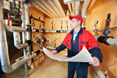 Heating engineer repairman in boiler room clipart