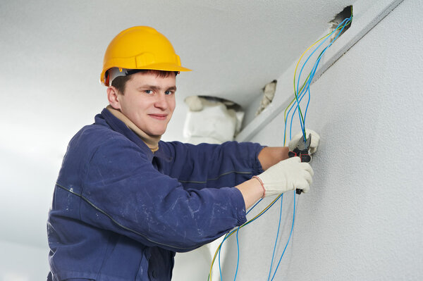Electrician at cable wiring work