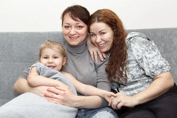 Portrait of two happy adults and little child — Stock Photo, Image
