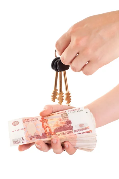 House key in hand and cash money in other hand — Stock Photo, Image