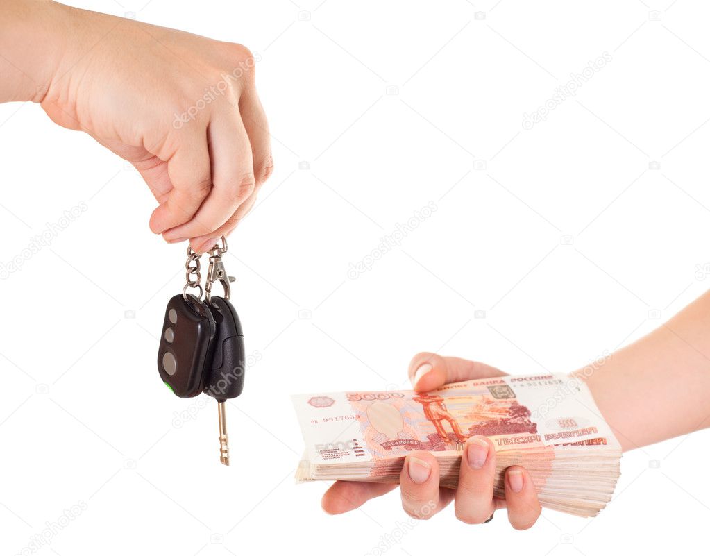 Car key in hand and cash money in other hand isolated ob white background