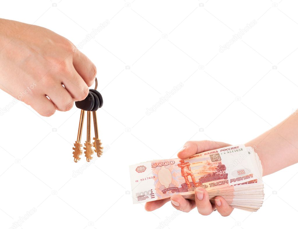 House key in hand and cash money in other hand isolated ob white