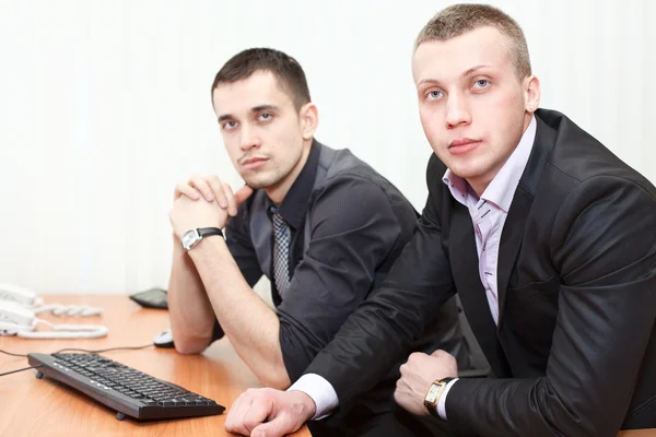 Two business men looking together at computer screen Stock Image