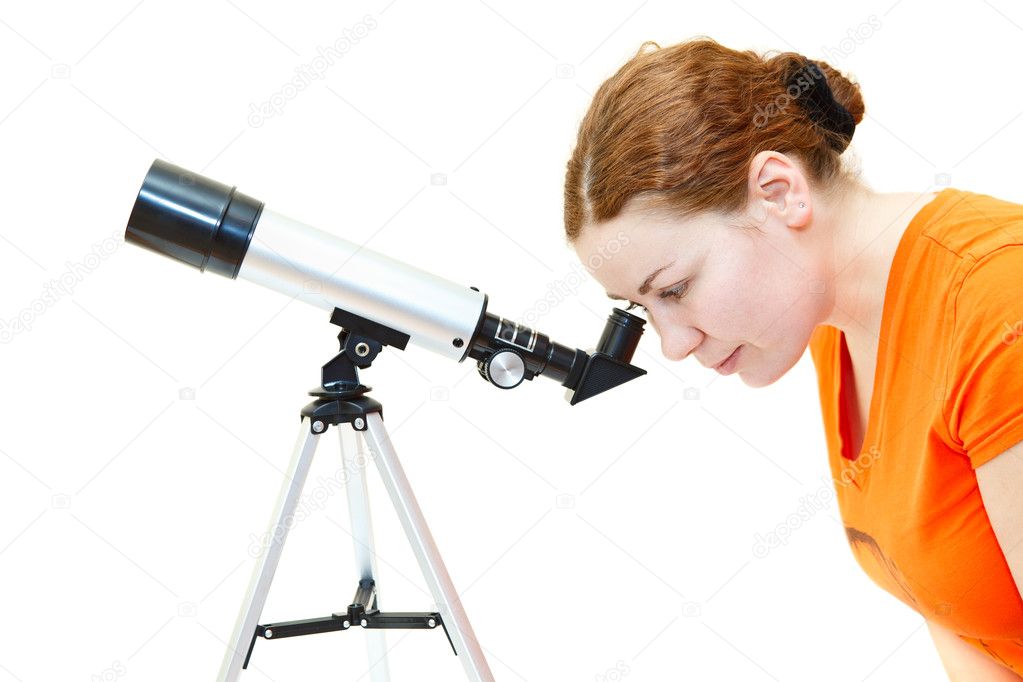 Young woman in orange t-shirt looking through telescope on white background