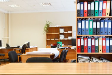 Modern office interior with tables, chairs and bookcases clipart