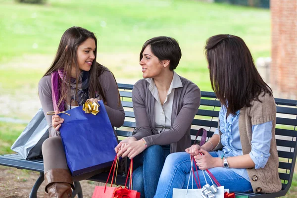 Jonge vrouwen in park na het winkelen — Stockfoto