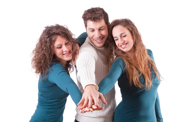 Três amigos felizes com as mãos na pilha — Fotografia de Stock