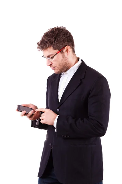 Mladý podnikatel s smartphone na bílém pozadí — Stock fotografie