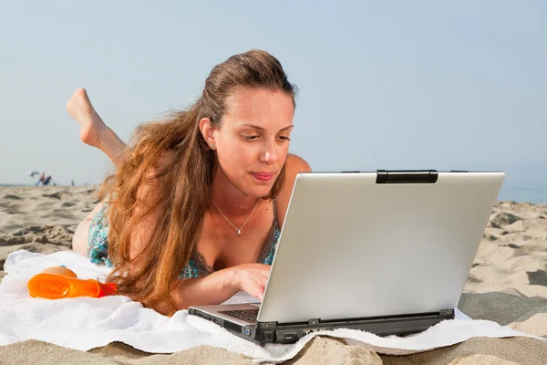 Donna che lavora al computer sulla spiaggia — Foto Stock
