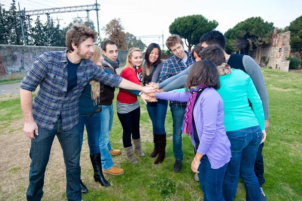 Multirassische Studenten mit Hands on Stack — Stockfoto