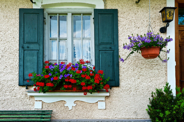 Bavarian Window with Open Wooden Shutters, Decorated With Fresh Flowers