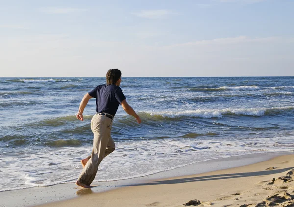 stock image Man running along seashore