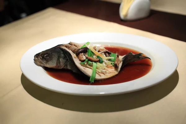 Sea bass on white plate — Stock Photo, Image