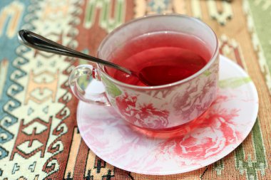 Cup of karkade tea clipart