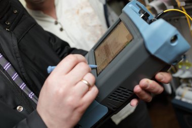 Engineer measuring fiber optic clipart