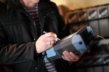 Network engineer measuring fiber optic clipart