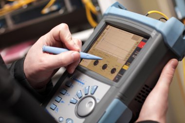 Network technician adjusting reflectometer clipart