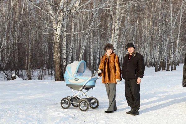 Family with baby carriage — Stock Photo, Image