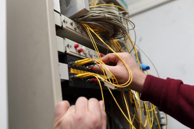 Technician attaching optical connector clipart