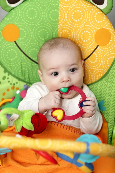 Baby biting rattle — Stock Photo, Image