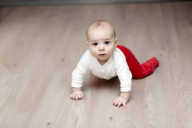 Serious baby on floor clipart