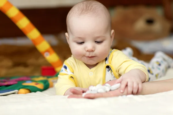 Baby taking pebbles — Stock Photo, Image