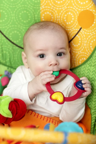 Baby with rattle ring — Stock Photo, Image