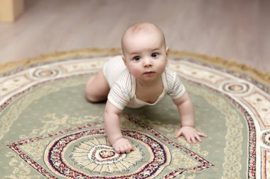 Baby crawling on carpet clipart