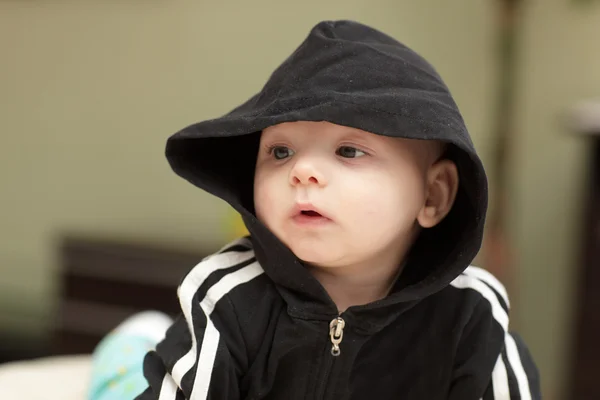 Baby in black hood — Stock Photo, Image