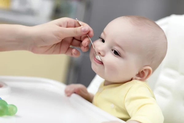 Baby eating with spoon — Stock Photo, Image
