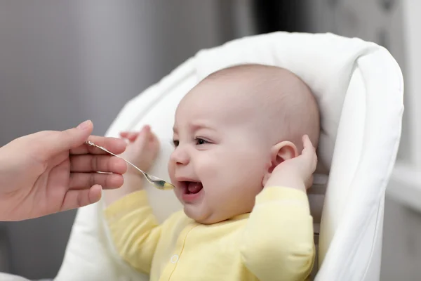 Crying baby with food — Stock Photo, Image